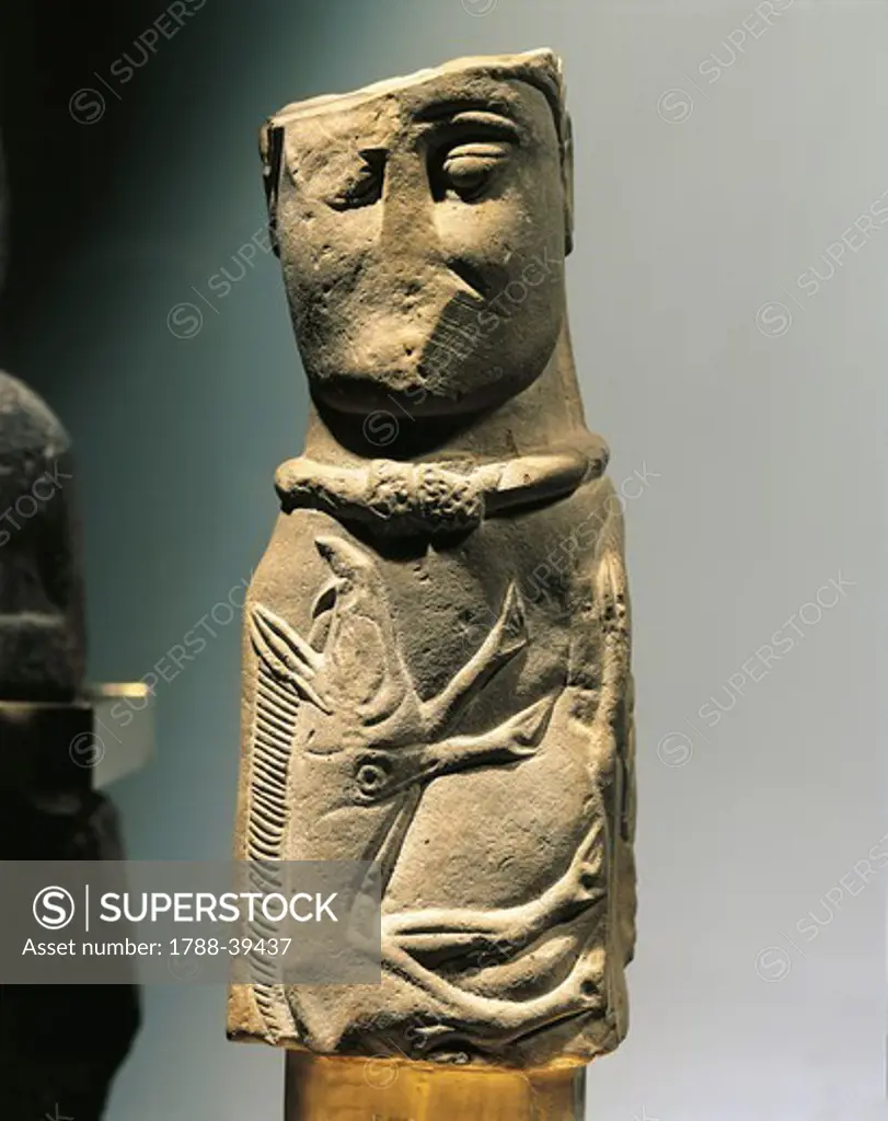 Celtic civilization, France, 1st century b.C. Male deity pillar statue with collar and carved wild boar on chest, in limestone. From Euffigneix.