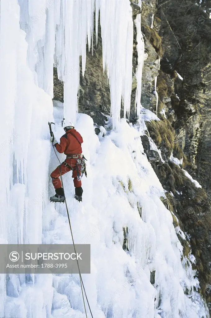 Italy - Piedmont Region - Varaita - Climber on a frozen waterfall