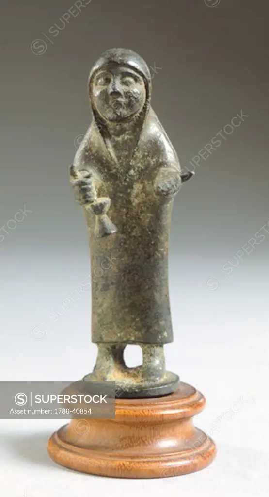 Female figure in bronze making an offering, front view. Etruscan Civilization, 625-600 BC.