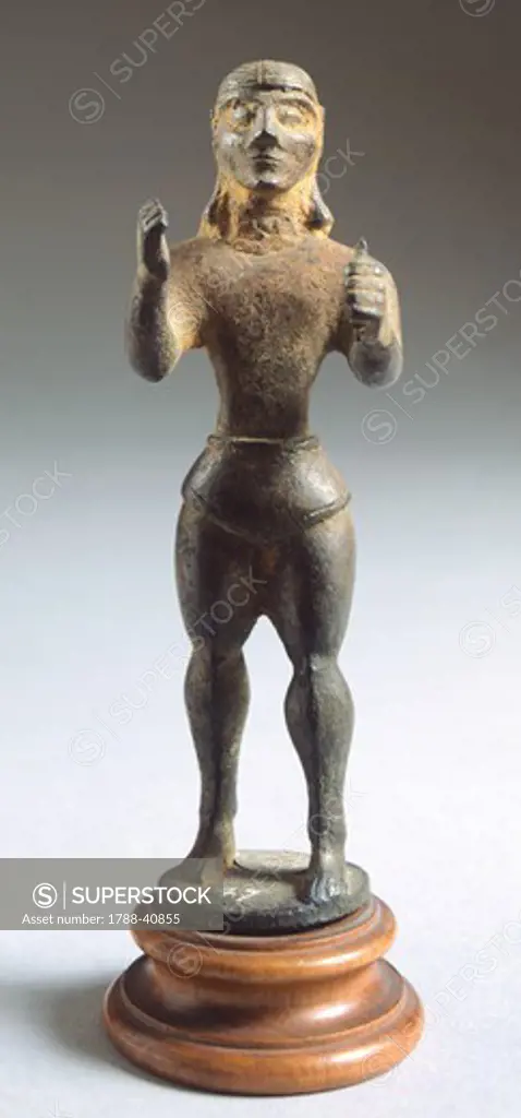 Bronze statue depicting armed figure making offering, front view. Etruscan Civilization, 625-600 BC.