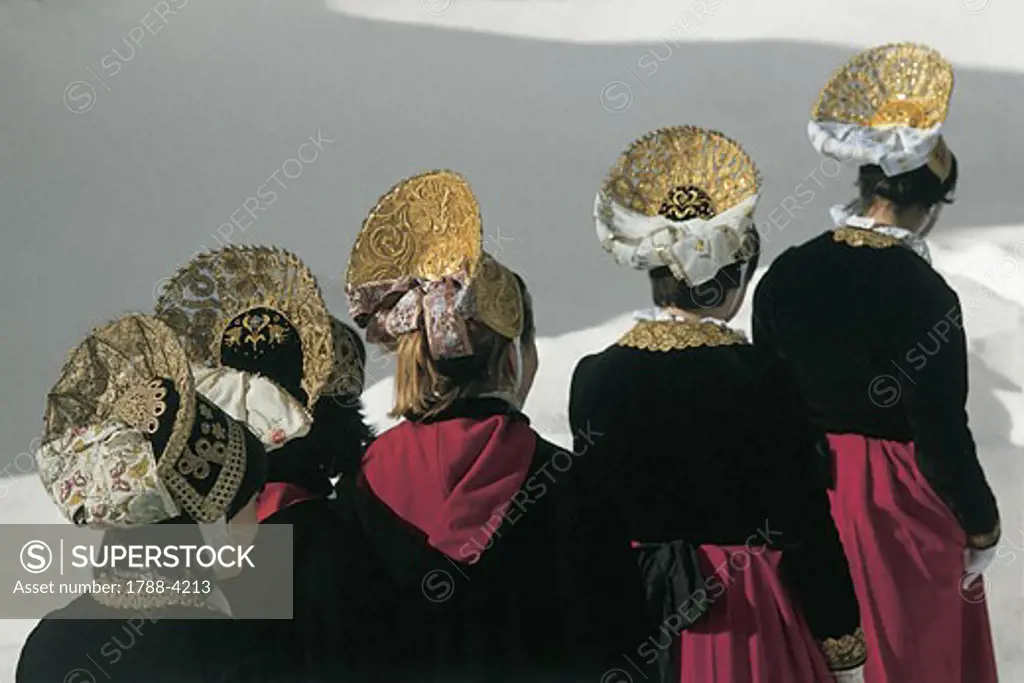 Rear view of five women standing in a row, Gressoney, Valle D'aosta, Italy