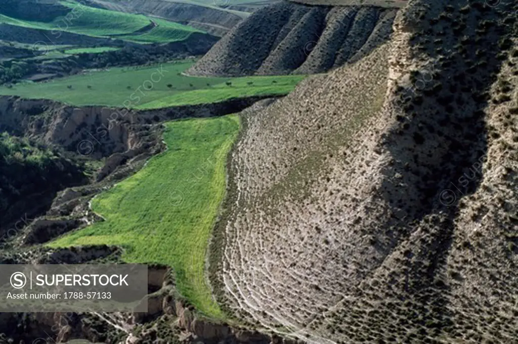 Ground stratification and formation of gorges, badlands and hills.