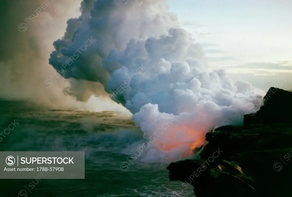Lava flow flowing into the sea creating clouds of water vapour, Hawaii Volcanoes National Park (UNESCO World Heritage List, 1987), Hawaii (The Big Island), Hawaii, United States.