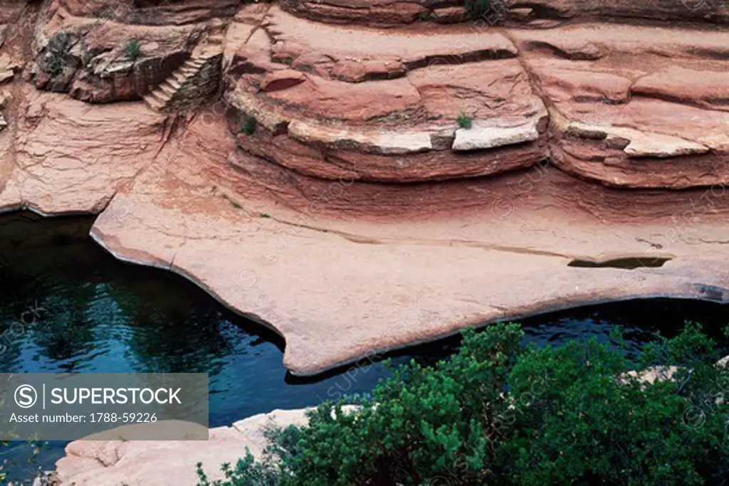Stream at the bottom of a deeply eroded canyon, protected area of Slide Rock, Oak Creek Canyon, Arizona, United States.