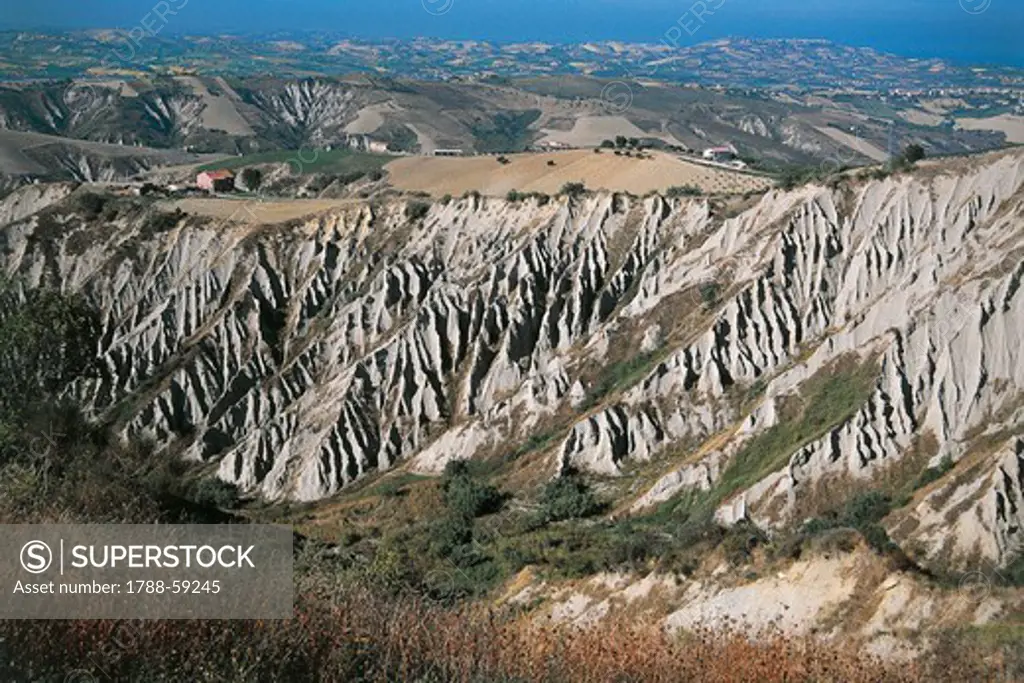 A view of the Badlands of Atri, formations created by soil erosion, known also as Dantesque pits of hell or called in dialect Scrimoni (Escarpments). Nature Reserve of the Calanchi ( Badlands ) of Atri, WWF Oasis, Abruzzo, Italy.