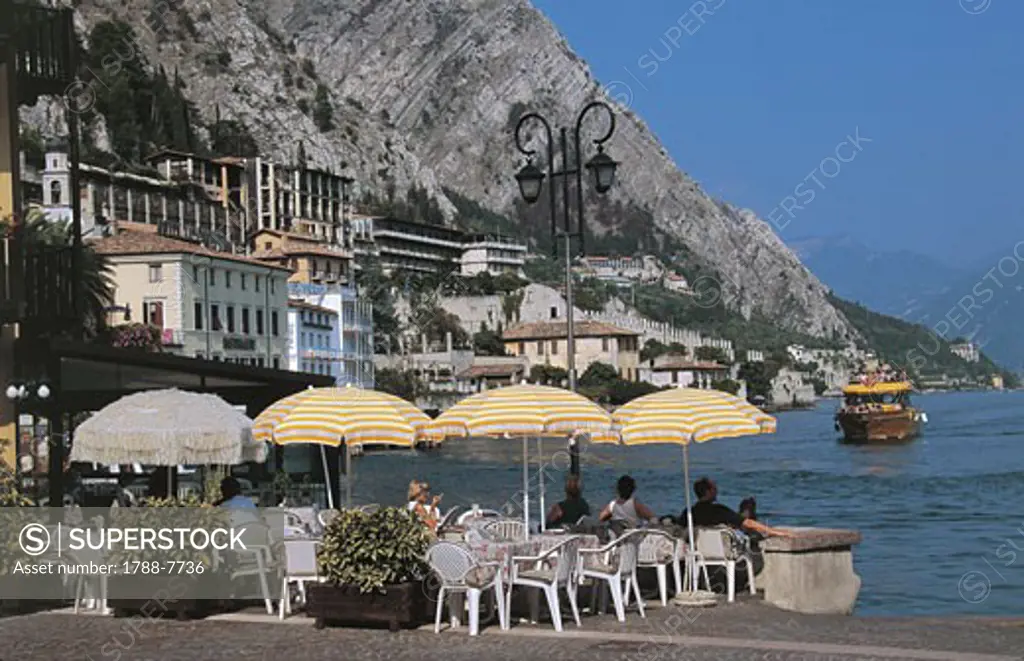 Tourists sitting in a sidewalk cafe, Limone sul Garda, Lake Garda, Lombardy, Italy