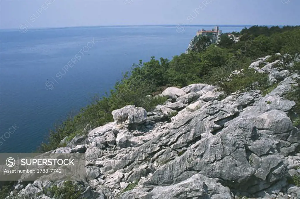 Karstic formations with a castle in the background, Duino Castle, Trieste, Friuli-Venezia Giulia, Italy