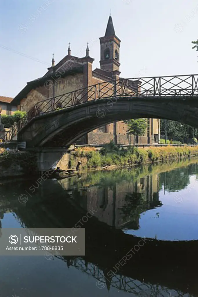 Bridge across the canal with a church in the background, Naviglio Grande, Milan, Lombardy, Italy