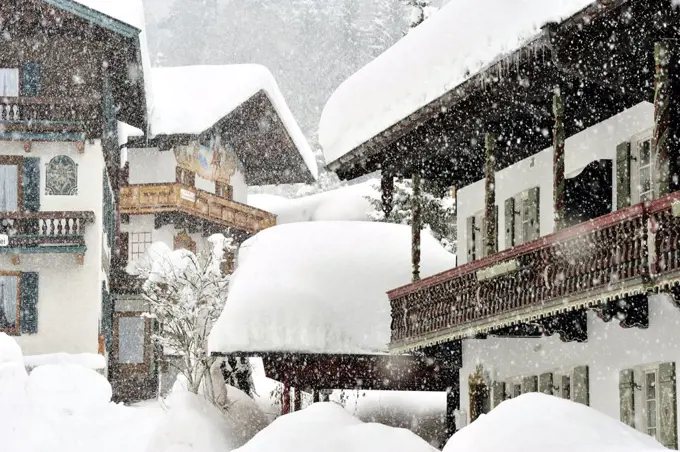 Houses under heavy snowfall in Reit im Winkl, Bavaria, Germany.