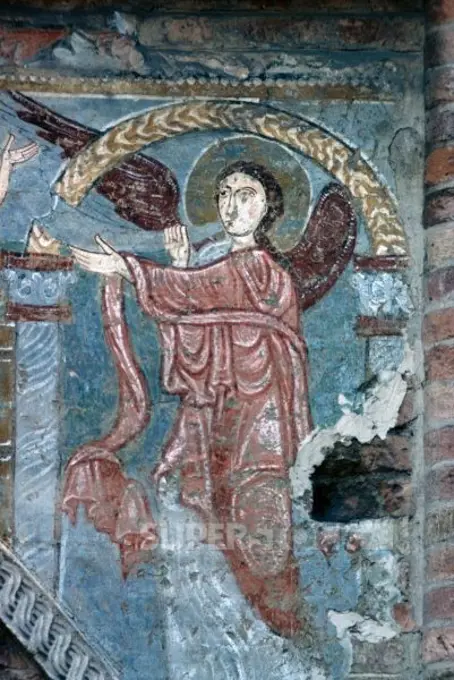 Angel playing trumpet, basilica of Santi Felice and Fortunato, Vicenza, Veneto. Italy, 11th century.