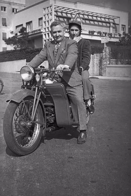 A couple on a motorcycle, 1950s, Genoa, Italy, 20th century.