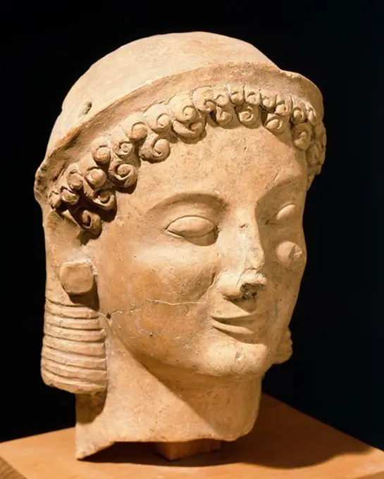 Female head, terracotta sculpture from Medma near Rosarno, Calabria, Italy. Ancient Greek civilization, Magna Graecia, 6th Century BC.