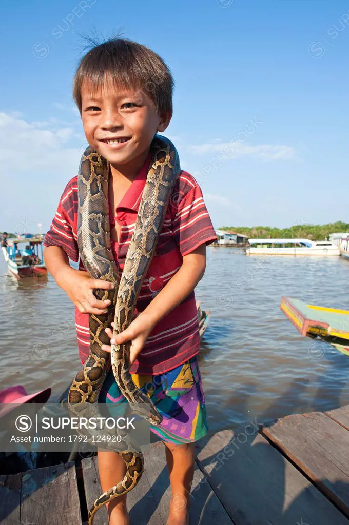 Cambodia, Siem Reap Province, Tonle Sap Lake, Biosphere Reserve by UNESCO, Chong Khneas floating village, small snake showman for the tourists´ deligh...