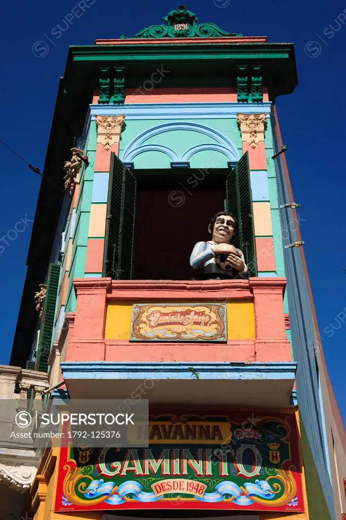 Argentina, Buenos Aires, La Boca district, colourful building of Caminito street and statue of Diego Maradonna on a balcony