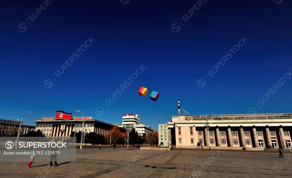 North Korea, Pyongyang, father and daughter playing kite