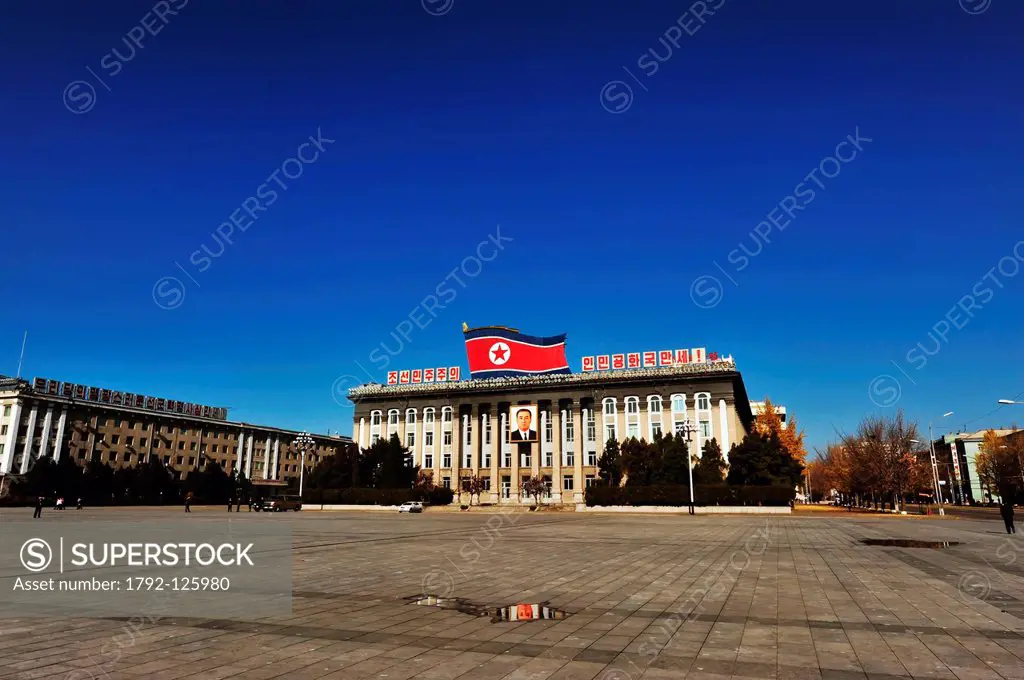 North Korea, Pyongyang government building with flag and portrait of the President