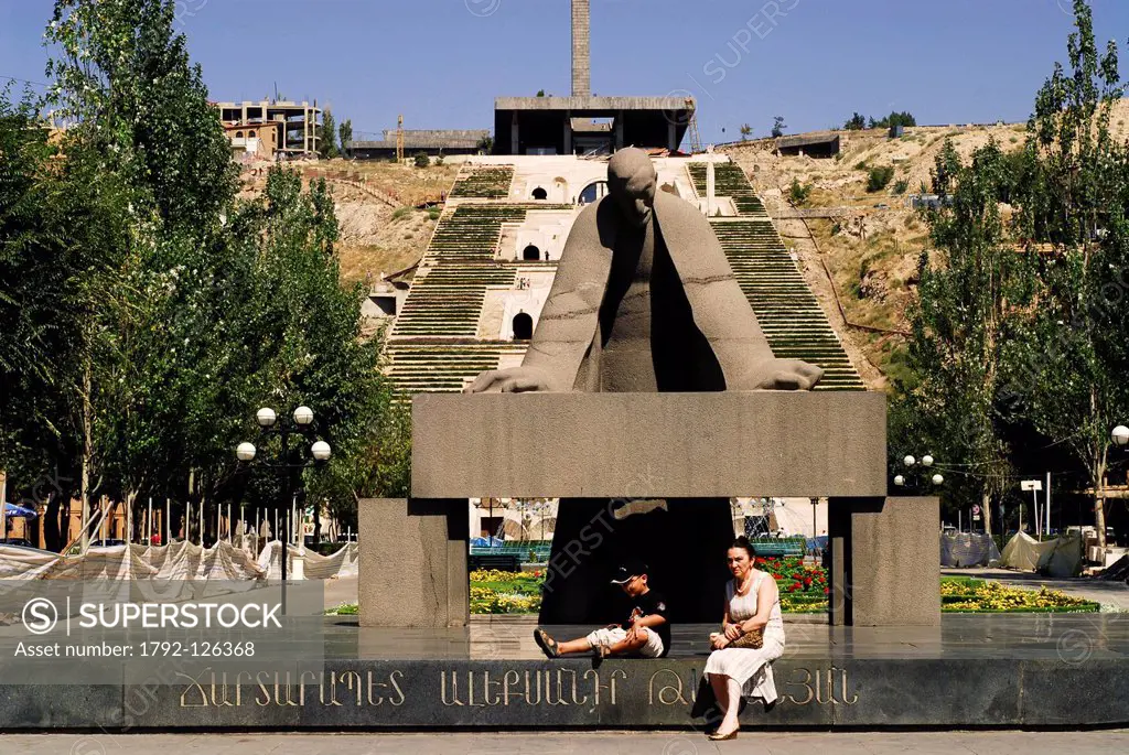 Yerevan, Armenia, Mother and child sitting at the bottom of Cascades, massive white steps that ascend from downtown Yerevan towards Haghtanak Park Vic...