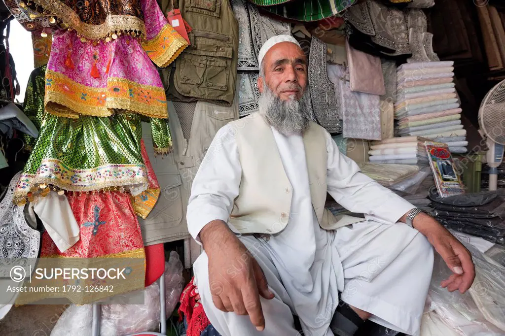 Afghanistan, Kabul, Chahari Sadarat, proud clothes seller