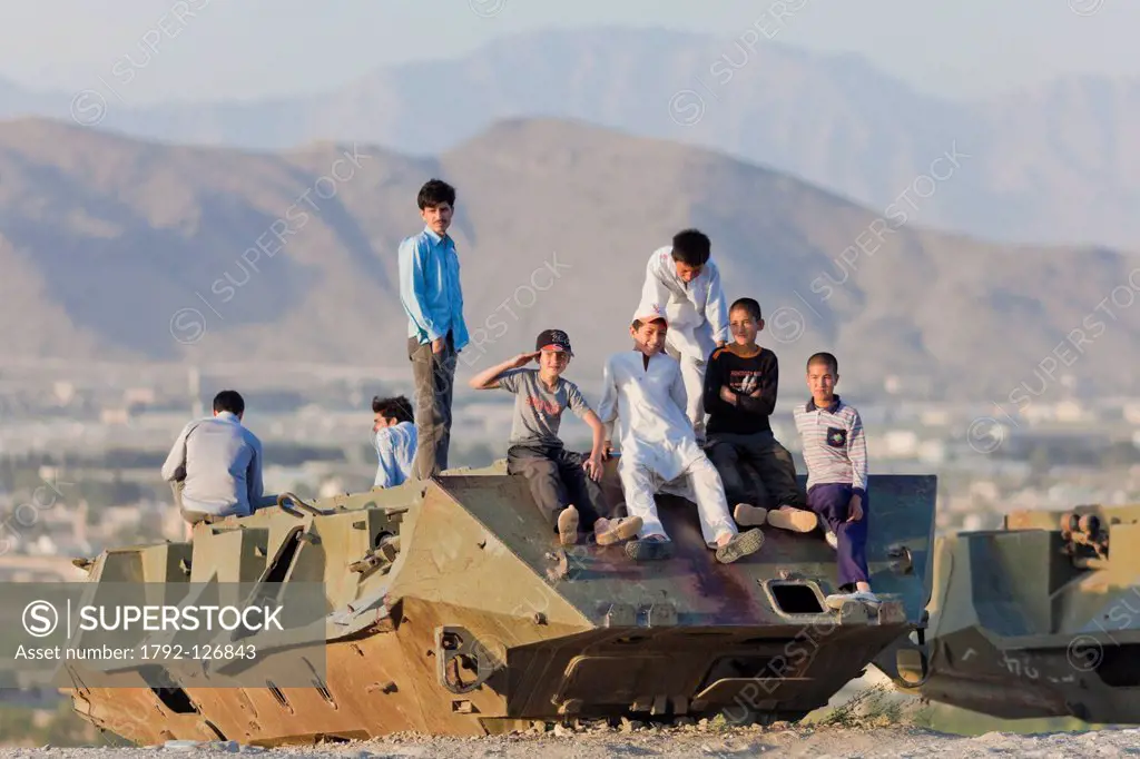 Afghanistan, Kabul, Bibi Maru Hill, boys playing on the wreck of a russian tank