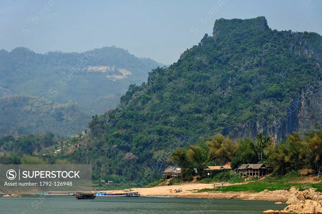 Laos, Luang Prabang Province, Mekong River, Pak Ou arrival of a flat_bottomed boat at the mouth of the Nam Ou River