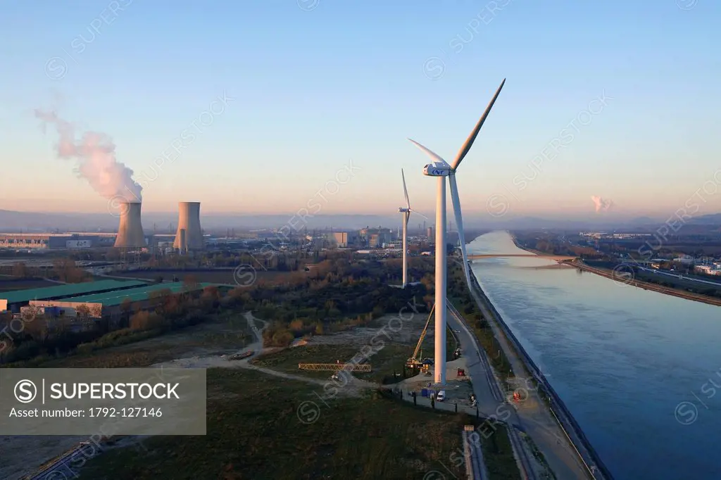 France, Vaucluse, Bollene wind turbine of CNR National Company of Rhone on Bollene industrial site, Tricastin industrial and nuclear site in the backg...
