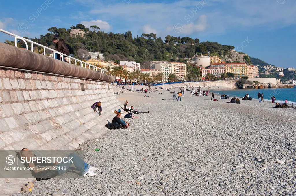 France, Alpes Maritimes, Nice, Promenade des Anglais in winter, the pebble beach and the Castle Hill
