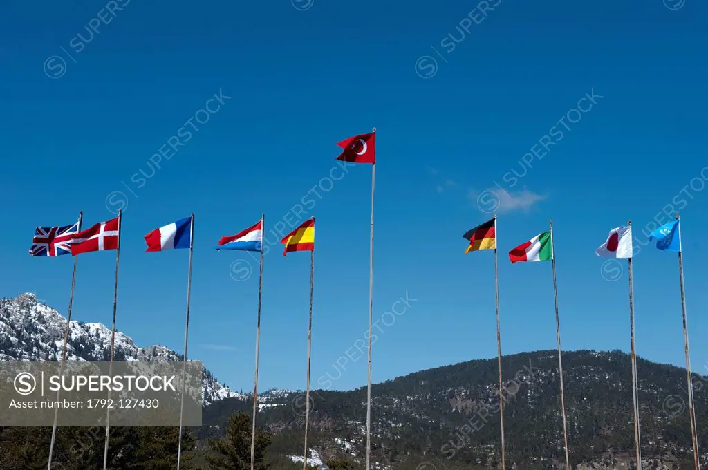 Turkey, Central Anatolia, Turkey´s flag among the flags of other countries, the Taurus mountains in the background