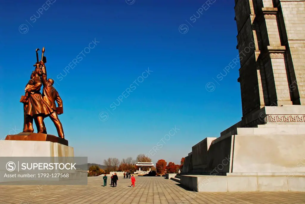 North Korea, Pyongyang, for a family posing in front of imposing statue