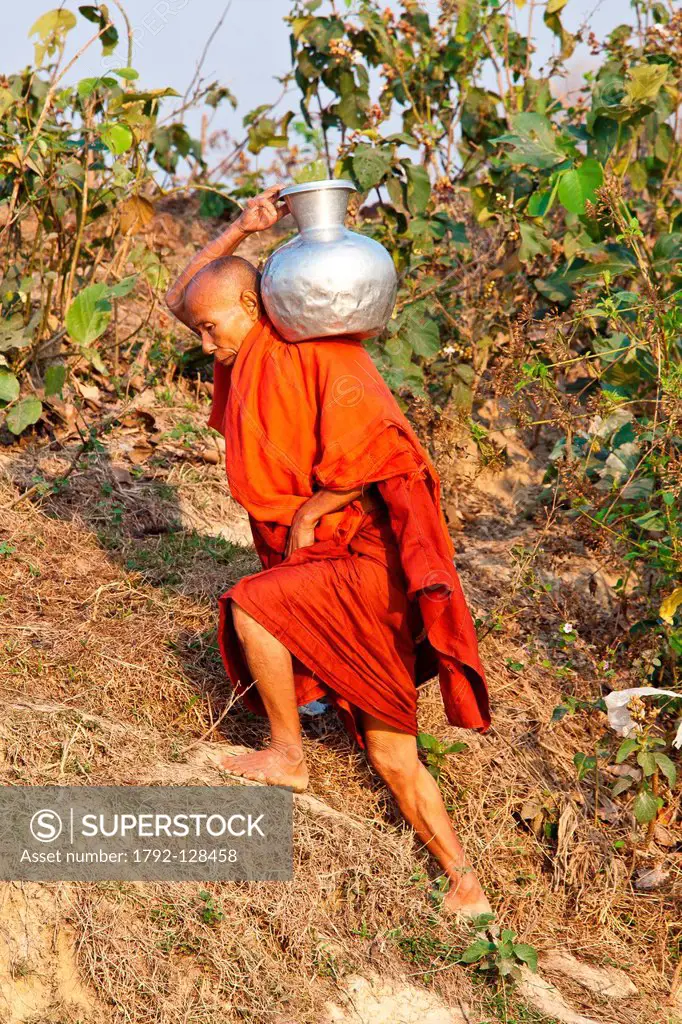 Myanmar Burma, Rakhine Arakan state, Mrauk U, monk carrying water