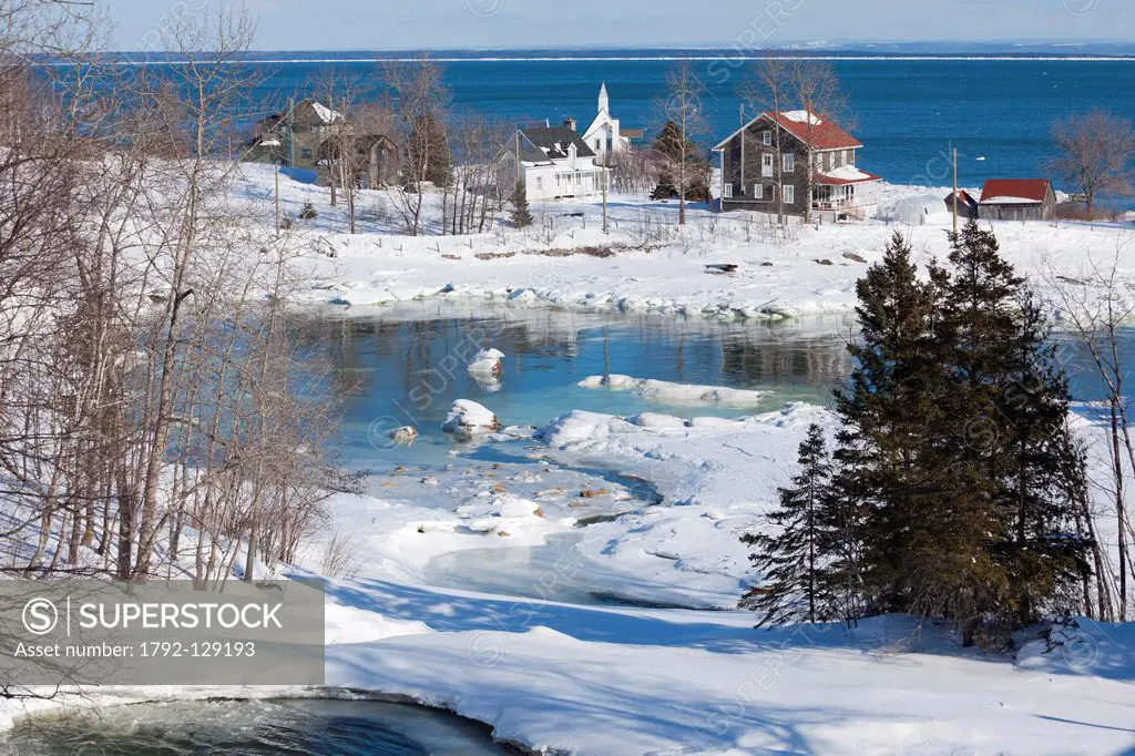 Canada, Quebec province, Charlevoix region, the St Lawrence River Road, Port au Persil, the frozen waterfall in winter and in background the village a...