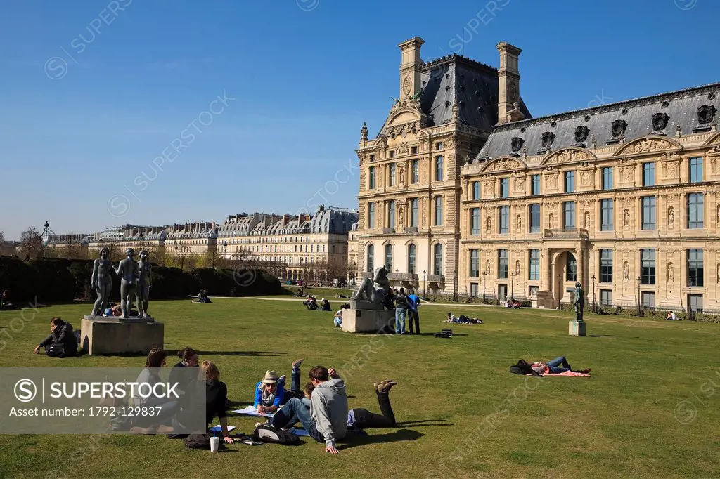 France, Paris, people sunbathing in the gardens of the Louvre Museum