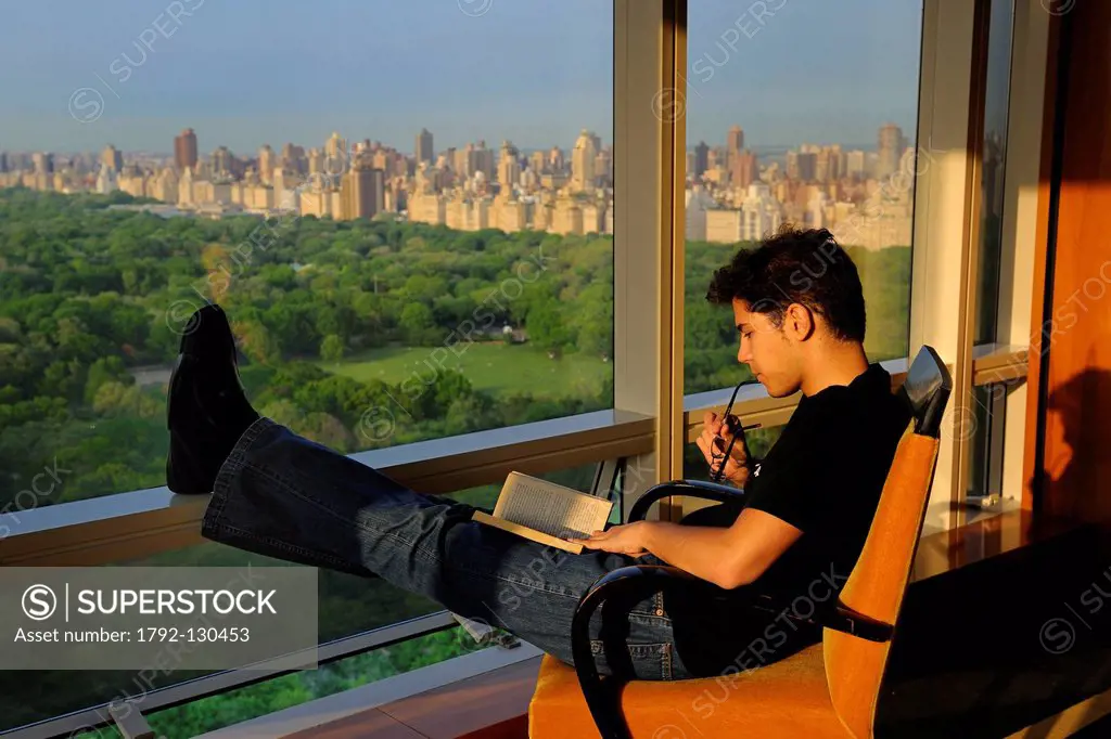 United States, New York City, Manhattan, reading a book facing Central Park
