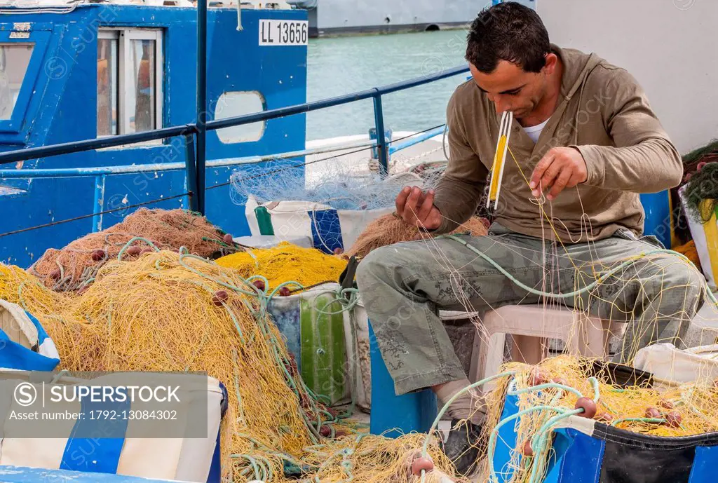 Cyprus, Lakki (Latsi), fishing port, fisherman mending his nets