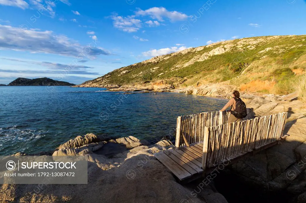 France, Var, Saint Tropez peninsula, Cap Taillat, walker on a wooden footbridge of the littoral path at the Point of Canadel