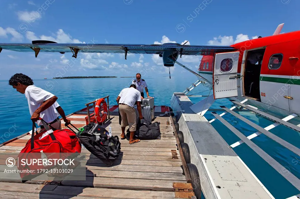 Maldives, seaplane of Maldivian Air Taxi company, unloading luggage