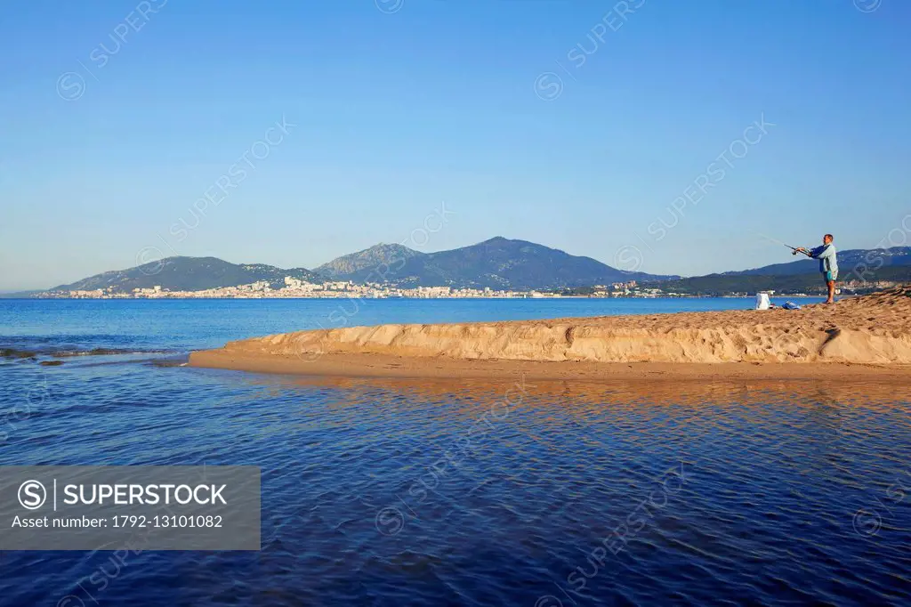 France, Corse du Sud, Gulf of Ajaccio, Ajaccio, beach Ricanto, mouth Prunelli, fisherman, Ajaccio in the background