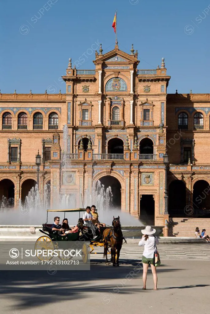 Spain, Andalucia, Seville, Spain Square, built by architect Anibal Gonzalez for the Ibero-American Exhibition of 1929, carriage rides, woman taking a ...