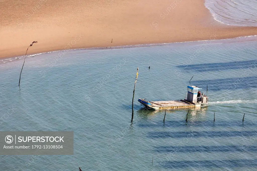 France, Charente Maritime, Ile d'Oleron, Dolus d'Oleron, boat in an oyster farm (aerial view)