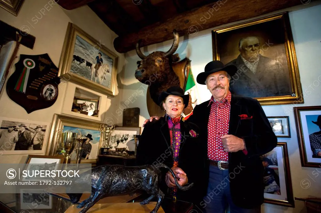 France, Bouches du Rhone, Camargue, Salin de Giraud, the ranchers Henri and Annie Laurent under the portrait of the father rancher Paul Laurent and th...