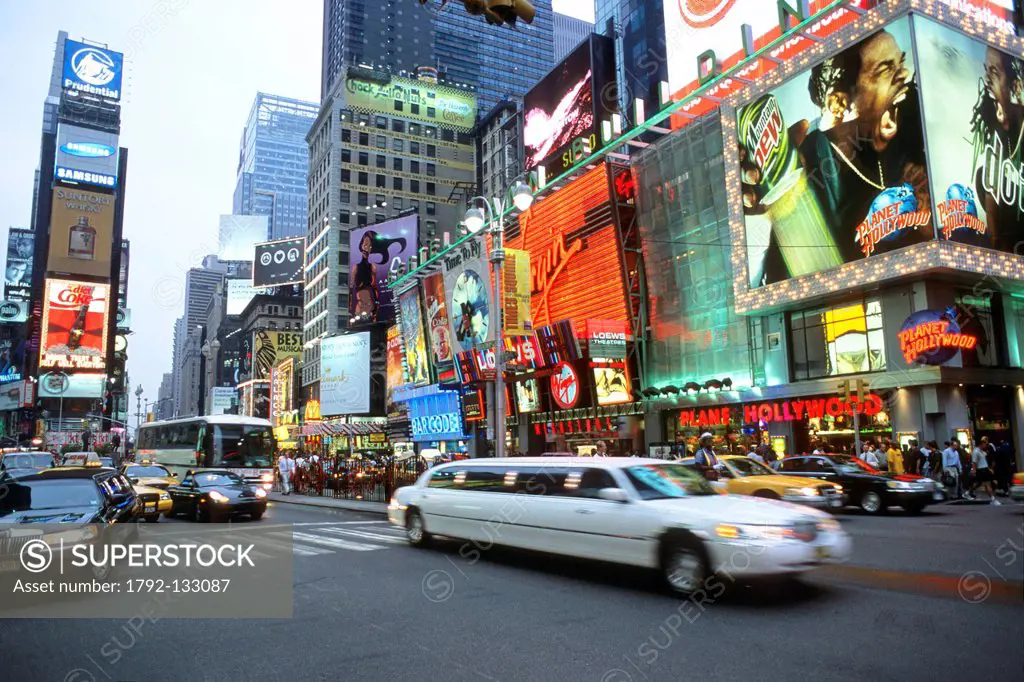 United States, New York City, Manhattan, Times Square, white limousine passing by the screen displays and advertising of Times Square on Broadway