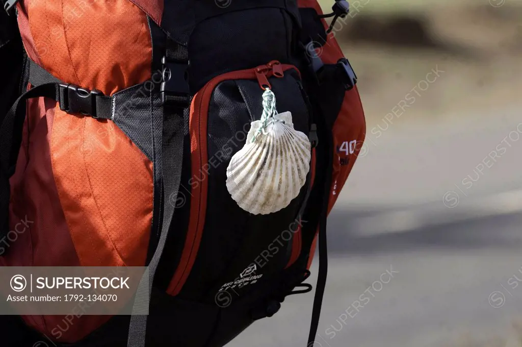 Spain, Castile and Leon, Cruz de Ferro, pilgrim´s bagpack with the Santiago shell, symbol of the spiritual quest, at the passage atop the Irago pass a...