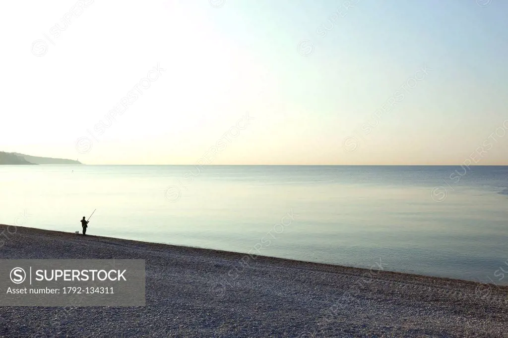 France, Alpes Maritimes, Nice, Baie des Anges, a fisherman on the beach of the Promenade des Anglais