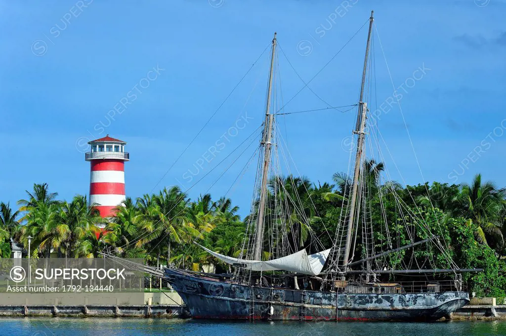 Bahamas, Grand Bahama Island, Freeport, Port Lucaya, Ghost, boat of Pirates of the Caribbean movie with lighthouse in background