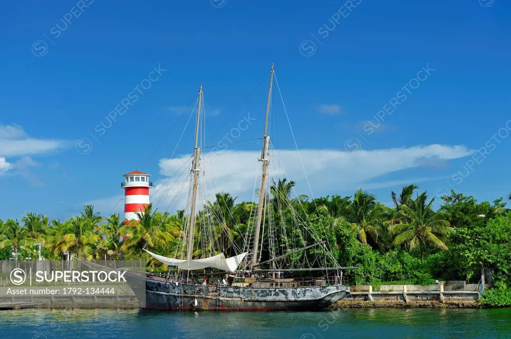 Bahamas, Grand Bahama Island, Freeport, Port Lucaya, Ghost, boat of Pirates of the Caribbean movie with a lighthouse in background