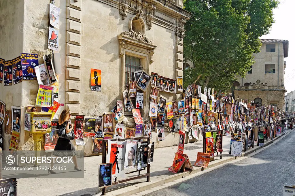 France, Vaucluse, Avignon, Rue des Lices, Festival d´Avignon, display wild on the walls of the city advertising shows, festival goers strolling along ...