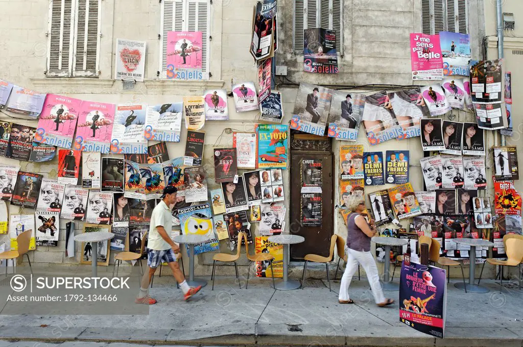 France, Vaucluse, Avignon, Rue des Lices, Avignon Festival, display wild on the walls of the city advertising shows, festival goers strolling along th...