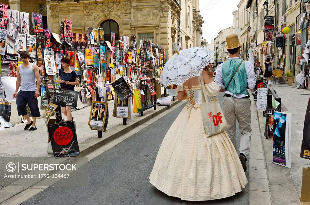 France, Vaucluse, Avignon, Rue des Lices, Avignon Festival, couple of actors in Belle Epoque costume in the middle of the street approaching people fo...
