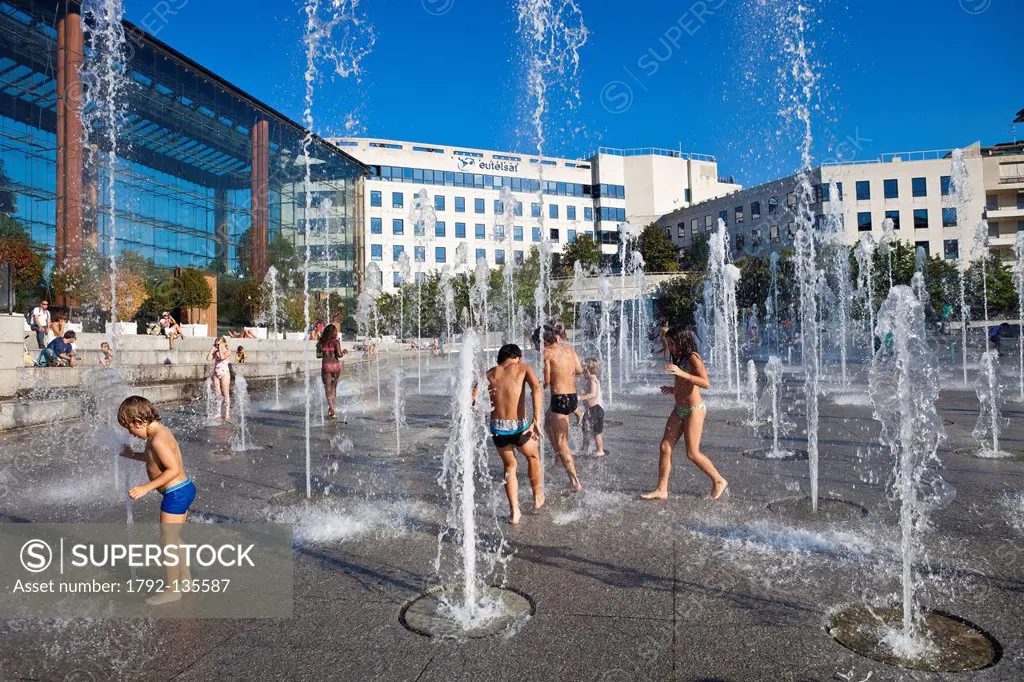 France, Paris, Andre Citroen park, 120 water jets are used as playground for children on hot summer days