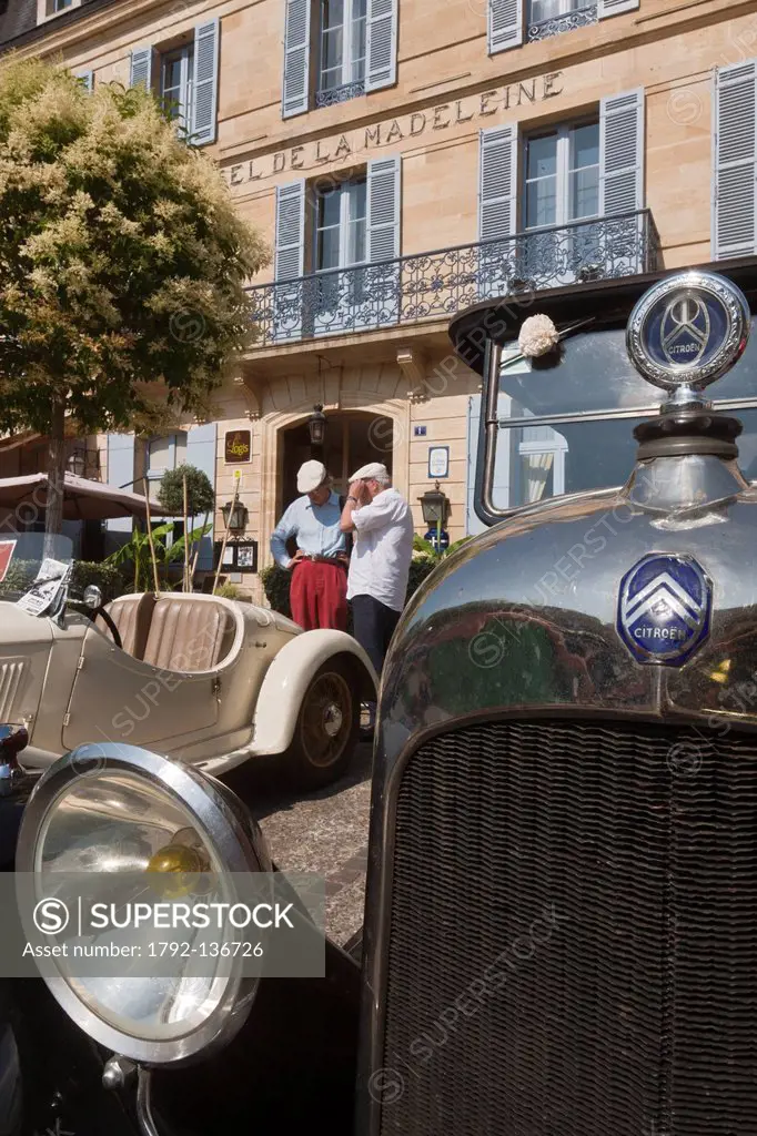 France, Dordogne, Sarlat, When passing a vintage car rally in front of Hotel de la Madeleine, the little place Rigaudie