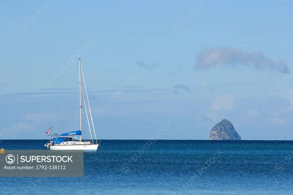 France, Martinique French West Indies, Sainte Anne, sailboat in the bay with the rocher du diamant diamond rock in the background